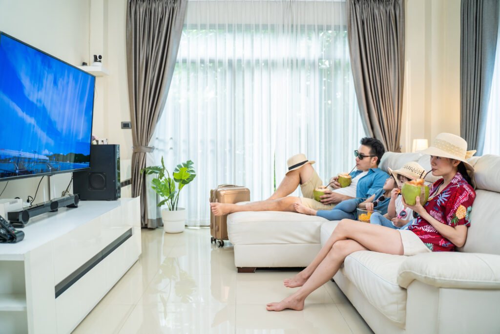 Guest relaxing in a vacation rental with high-speed Wi-Fi and smart TV enjoying one of the best vacation rental amenities.
